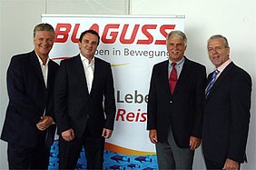 Uwe Schmidt, Paul Blaguss, Otmar Lenz, Gerhard Widmann vor einem Blaguss-Plakat